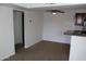 Open living room and kitchen featuring neutral carpeting and a ceiling fan, perfect for comfortable living at 5877 N Granite Reef Rd # 2257, Scottsdale, AZ 85250
