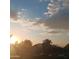 Sunset view over houses and trees, with fluffy clouds in the sky at 5877 N Granite Reef Rd # 2257, Scottsdale, AZ 85250