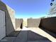Backyard features a gate, door, and partial patio at 600 S Dobson Rd # 148, Mesa, AZ 85202