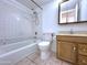 Bathroom features a shower-tub combo, white tile walls, and a wooden vanity with a sink at 600 S Dobson Rd # 148, Mesa, AZ 85202