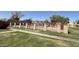 Fenced community pool surrounded by lush green grass with some bare spots during winter season at 600 S Dobson Rd # 148, Mesa, AZ 85202
