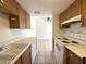 An open-concept floor plan connects living space to kitchen with white appliances and wood cabinets at 600 S Dobson Rd # 148, Mesa, AZ 85202