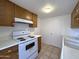 This kitchen features white countertops, wooden cabinets, and a range and oven combo at 600 S Dobson Rd # 148, Mesa, AZ 85202