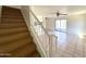 A view of the staircase shows the connection to the upper floor and the living space at 600 S Dobson Rd # 148, Mesa, AZ 85202