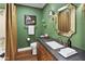 Stylish bathroom featuring a modern vanity with stone countertop, gold fixtures, and shower with beige curtain at 613 E Vista Ave, Phoenix, AZ 85020