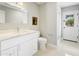 Bright bathroom featuring vanity with white marble countertop and seamless glass shower at 613 E Vista Ave, Phoenix, AZ 85020