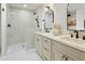 Elegant bathroom features a walk-in shower and double vanity with marble countertops and stylish fixtures at 613 E Vista Ave, Phoenix, AZ 85020