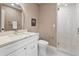 Bright bathroom featuring vanity with white marble countertop and seamless glass shower at 613 E Vista Ave, Phoenix, AZ 85020