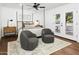 Bright bedroom features neutral tones, modern ceiling fan, stylish decor, and French doors to the outside at 613 E Vista Ave, Phoenix, AZ 85020