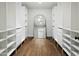 Spacious walk-in closet with custom shelving and drawers, illuminated with modern lighting at 613 E Vista Ave, Phoenix, AZ 85020