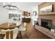 Open concept dining area featuring brick fireplace, wood table and chairs, and modern lighting at 613 E Vista Ave, Phoenix, AZ 85020