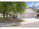 Charming home featuring a two-car garage, manicured lawn and mature trees offering a welcoming curb appeal at 613 E Vista Ave, Phoenix, AZ 85020