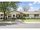 Charming single-story home with a stone facade, manicured lawn, and mature shade trees, boosting curb appeal at 613 E Vista Ave, Phoenix, AZ 85020