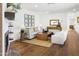 Bright living room with fireplace, neutral furniture, wood floors, and stylish decor at 613 E Vista Ave, Phoenix, AZ 85020