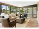 Inviting sunroom with brick floors, large windows, and comfortable seating for relaxing and enjoying the natural light at 613 E Vista Ave, Phoenix, AZ 85020