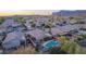 An aerial perspective of a residential neighborhood highlighting homes, driveways, and the surrounding landscape at 6853 S Russet Sky Way, Gold Canyon, AZ 85118
