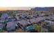 Aerial view showcases a suburban neighborhood with mountain views, homes, driveways, and surrounding foliage at 6853 S Russet Sky Way, Gold Canyon, AZ 85118