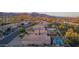 Aerial view of houses with mature trees, lush vegetation, swimming pools, and beautiful mountain scenery at 6853 S Russet Sky Way, Gold Canyon, AZ 85118