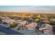 Wide aerial view of a well-planned community nestled against scenic mountains with lush desert landscaping at 6853 S Russet Sky Way, Gold Canyon, AZ 85118