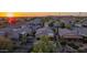 Aerial view showcasing the suburban homes, lush foliage, and well-maintained streets of the neighborhood at dusk at 6853 S Russet Sky Way, Gold Canyon, AZ 85118