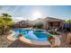 Backyard with a refreshing pool, spa, covered patio, and lush landscaping, perfect for outdoor enjoyment at 6853 S Russet Sky Way, Gold Canyon, AZ 85118