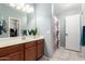 Bathroom features a single sink vanity, large mirror, and shower-tub combo at 6853 S Russet Sky Way, Gold Canyon, AZ 85118