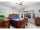 Comfortable bedroom featuring a wooden bed frame, bedside tables and bay windows at 6853 S Russet Sky Way, Gold Canyon, AZ 85118