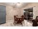 Cozy dining area with a wooden table, four chairs, and sliding glass doors at 6853 S Russet Sky Way, Gold Canyon, AZ 85118