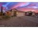 Home exterior with desert landscaping, garage, and a front entrance with updated finishes at 6853 S Russet Sky Way, Gold Canyon, AZ 85118