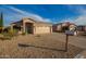 A well-maintained single Gathering home featuring desert landscaping, a two-car garage, and a mailbox out front at 6853 S Russet Sky Way, Gold Canyon, AZ 85118