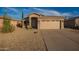 Charming front exterior displaying a neutral color palette, desert landscaping, and a two-car garage at 6853 S Russet Sky Way, Gold Canyon, AZ 85118