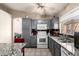 Well-lit kitchen featuring gray cabinets, granite countertops, and stainless steel appliances at 6853 S Russet Sky Way, Gold Canyon, AZ 85118