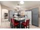 Modern kitchen with gray cabinets, granite countertops, an island with seating, and stainless steel appliances at 6853 S Russet Sky Way, Gold Canyon, AZ 85118