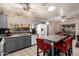 Stylish kitchen featuring gray cabinets, granite countertops, an island with seating, and stainless steel appliances at 6853 S Russet Sky Way, Gold Canyon, AZ 85118