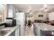 Open kitchen with gray cabinets, granite countertops, seamlessly flowing into the dining and living area at 6853 S Russet Sky Way, Gold Canyon, AZ 85118