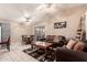 Open-concept living room featuring tile floors, ceiling fans, dining table, and comfortable seating area at 6853 S Russet Sky Way, Gold Canyon, AZ 85118