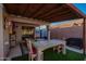 Outdoor patio with wooden pergola, table and chairs, BBQ and a shed on artificial grass at 6853 S Russet Sky Way, Gold Canyon, AZ 85118