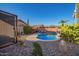 Sparkling pool with a unique rock landscape, cacti, and desert plants in a well maintained yard at 6853 S Russet Sky Way, Gold Canyon, AZ 85118