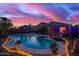 Stunning pool area with a spa, rock landscaping, and a covered patio perfect for entertaining during sunset at 6853 S Russet Sky Way, Gold Canyon, AZ 85118