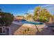 Backyard oasis with a sparkling pool, patio furniture, lush trees, and well-manicured desert landscaping at 6853 S Russet Sky Way, Gold Canyon, AZ 85118
