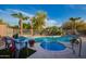Gorgeous pool and spa surrounded by lush landscaping, a flag pole, and decorative patio furniture at 6853 S Russet Sky Way, Gold Canyon, AZ 85118