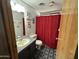Cozy bathroom featuring a decorative floor, stylish fixtures, and a vibrant shower curtain at 6960 W Peoria Ave # 212, Peoria, AZ 85345