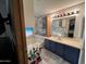 Well-lit bathroom with a soaking tub, vanity with storage, and stylish coastal decorations at 6960 W Peoria Ave # 212, Peoria, AZ 85345