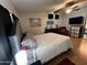 Bedroom with wood-look flooring, ceiling fan, and a queen-sized bed at 6960 W Peoria Ave # 212, Peoria, AZ 85345