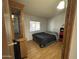 Simple bedroom features a bed, wooden cabinet, and a window that allows natural light at 6960 W Peoria Ave # 212, Peoria, AZ 85345