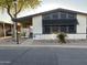 Manufactured home featuring desert landscaping, covered parking, and shaded front porch at 6960 W Peoria Ave # 212, Peoria, AZ 85345