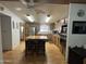 Well-equipped kitchen with a center island, wooden cabinets, and stainless steel appliances at 6960 W Peoria Ave # 212, Peoria, AZ 85345