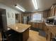 Bright kitchen featuring wood cabinets, stainless steel appliances, and functional island at 6960 W Peoria Ave # 212, Peoria, AZ 85345