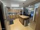 Spacious kitchen featuring wood cabinetry, stainless steel appliances, and island with seating at 6960 W Peoria Ave # 212, Peoria, AZ 85345