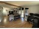 Open living room featuring wood floors, large windows, and comfortable seating at 6960 W Peoria Ave # 212, Peoria, AZ 85345